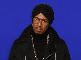 Celebrity gif. Nick Cannon nods at us and gives us two thumbs up as he smiles.