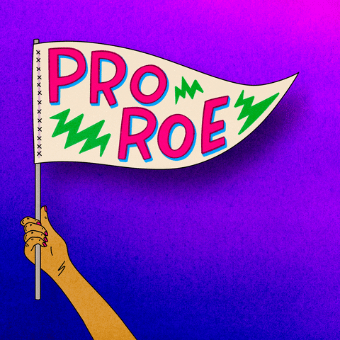 Digital art gif. Animation of a hand with pink fingernails waves a pennant in the air, text inside of which reads, "Pro Roe," in all-caps, pink font, all against an ombre pink and blue background.
