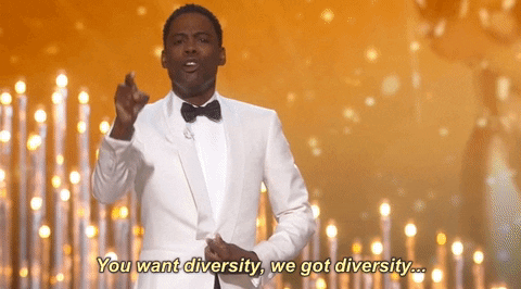 Chris Rock points enthusiastically. caption: you want diversity, we got diversity