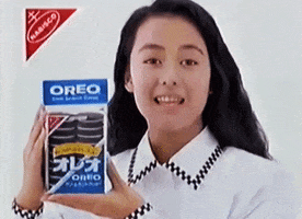 Ad gif. Japanese celebrity Kamiko Goto holds up a pack of Oreos with Japanese packaging as she smiles and speaks to us.