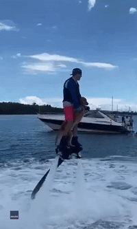 Dog Flies Through the Air With Owner on Jetpack