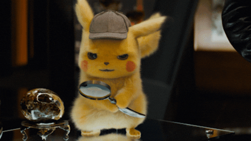 Detective Pikachu looking through a magnifying glass.