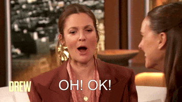 TV gif. Drew Barrymore on her eponymous show looks surprised and confused as she reacts to a guest seated on her couch, gesturing in a dramatic way and then leaning forward like she needs a moment to collect herself. Text, "Oh! Ok!'