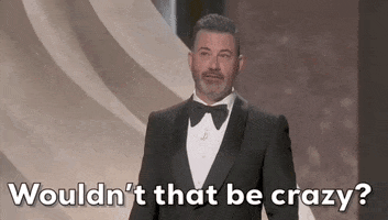 Oscars 2024 GIF. Jimmy Kimmel retells a story of a man streaking at a past Oscar's event. He stares out into the crowd and says, "Wouldn't that be crazy?" while a shirtless John Cena slowly walks out and peeks behind a wall on stage. 