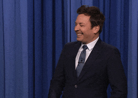 Tonight Show gif. Fallon clutches his face in his palm as he cracks up.