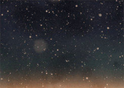 Digital art gif. Out of focus snow particles fall gently over a cloudy dark blue to soft orange ombre background.