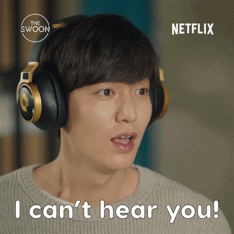 GIF of an Asian man wearing headphones saying I can't hear you.