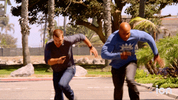 TV gif. In an episode of "NCIS: Los Angeles," LL Cool J as Sam Hanna and Chris O'Donnell as G. Callen are seen sprinting away from something--something which, moments later, explodes in a burst of flames. 