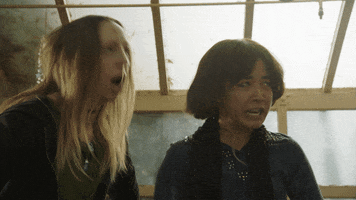 TV gif. Maya Erskine as Maya Ishii-Peters and Anna Konkle as Anna Kone in PEN15 violently gyrate and rock their heads, their eyes rolling back.