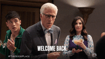 TV gif. Ted Danson as Michael on The Good Place leans forward and says, “Welcome back.”