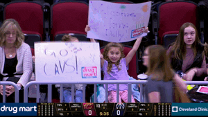 Sports gif. In the stands at basketball game, two children hold up signs that read "Go Cavs!" and "Welcome Home Delly!"
