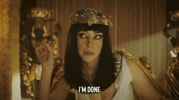 TV gif. Aubrey Plaza as Cleopatra on Drunk History. She's leaning forward in her throne and she rolls her eyes while waving her fingers, saying, "I'm done."