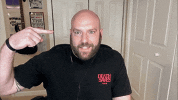 Video gif. Mike Haracz on Roosterteeth looks at us with wide eyes and a smile. He points at himself and says, “Me.”