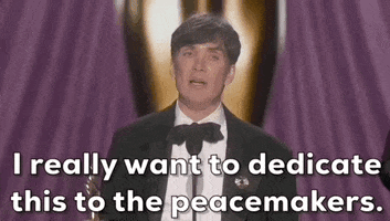 Oscars 2024 GIF. Cilllian Murphy wins Best Actor. He holds the trophy as he pumps out his arm and says, "I really want to dedicate this to the peacemakers."
