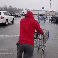 Man Slides Across Icy Parking Lot to Return Shopping Cart