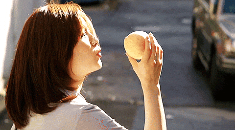 woman kissing peach