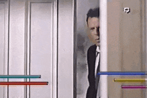 Celebrity gif. Bruce Willis opens a door and walks into a room with a serious expression of concern on his face. Bars of colors shoot across the screen to display the word, “Tuesday.”
