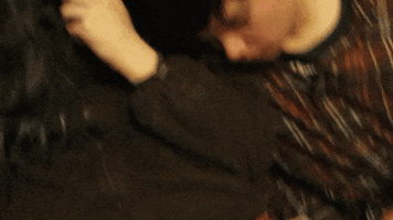 Video gif. A sleeping boy rests his head on the shoulder of a girl with glasses.