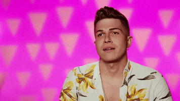 Reality TV gif. Alyssa Hunter on RuPaul's Drag Race sits out of drag for an interview in front of a pink background, giving a quick sassy side eye, raising his eyebrows and pursing his lips as if unimpressed.