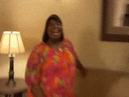 Parks and Recreation gif. Retta as Donna smiles excitedly with wide eyes and an open mouth. 
