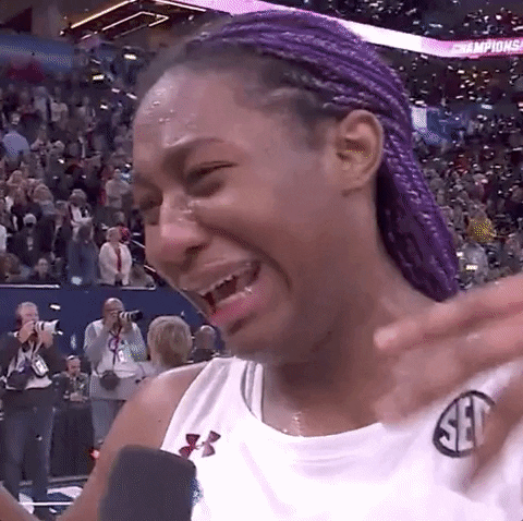 Sports gif. South Carolina player Aliyah Boston crying at the end of an NCAA game, wiping away tears and fanning her face. Text, "happy tears!"