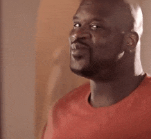 Meme gif. Shaquille O’Neal looks at us in the corner of his eye as he purses his lips in a flirty way. He shakes his shoulders and chest as he stares at us.