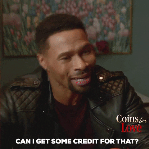 TV gif. Karon Riley as Jake on Coins for Love looks at Essence Atkins as Madison with a serious expression as he says, “Can I get some credit for that?” She lifts her eyebrows up in surprise and disappointment as she says, “Credit?!”