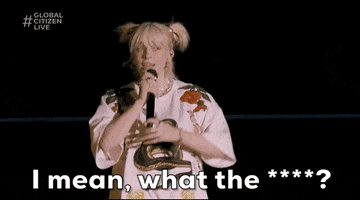 Celebrity gif. Billie Eilish yells into a microphone, with an arm raised for emphasis, then turns around and scratches the back of her head. Text: "I mean, what the ****?"