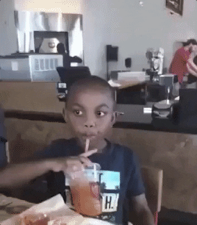 Video gif. We zoom in quickly on a young boy's face as he finishes taking a drink from a straw, turns his head to the side, then looks at us with eyes wide to say, "no," in exasperation.