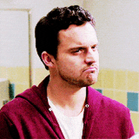 TV gif. Jake Johnson as Nick Miller in New Girl pouts, frowns, and shakes his head "no."