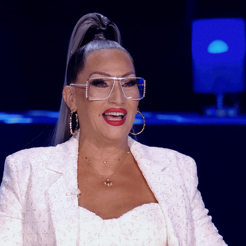 TV gif. An amazed Michelle Visage on RuPaul’s Drag Race stands up and applauds.
