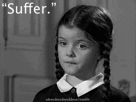 TV gif. A black-and-white scene of Lisa Loring as Wednesday Addams from The Addams Family, innocently telling us to: Text, "Suffer."