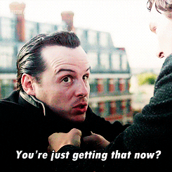 Dr. Moriarty is being clutched by Sherlock as he asks, "You're just getting that now?"