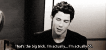 Celebrity gif. Nick Jonas sits in an interview and jokingly says, “That’s the big trick. I’m actually…I’m actually 55.”
