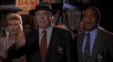 Movie gif. In a clip from The Naked Gun, three characters slap their own foreheads in astonishment. We then see a group of men in a video editing bay, then an entire audience slapping their foreheads, all in the same manner.