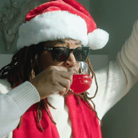 Ad gif. Man wears a Santa hat and sunglasses. He sips a small cup of Kool-Aid and then says, “ahh” from how refreshing it is.