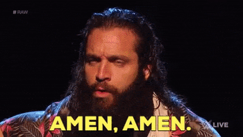 TV gif. Wrestler Elias has his eyes closed in a moment of what seems like quiet peace and shakes his head as he says, “Amen, Amen.” 