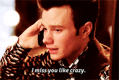 TV gif. Chris Colfer as Kurt in Glee. He's on the phone and looks very sad and is holding in tears as he says, "I miss you like crazy."