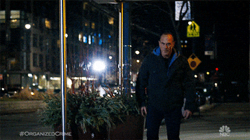 TV gif. Christopher Meloni as Detective Elliot on Law and Order: Organized Crime. He's walking on the streets but begins breaking out into a full out sprint as he spots something.