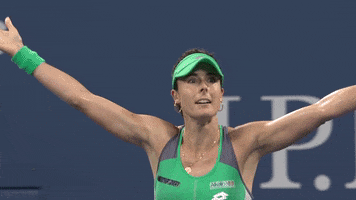 Sports gif. Tennis Player Alize Cornet raises her arms in the air and then throws them down to her side as she yells, “boom!”
