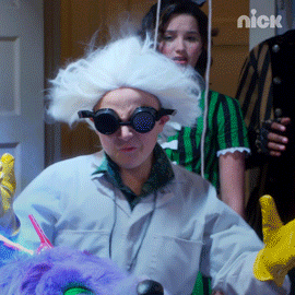 TV gif. Child on Nickelodeon wears a Doc Brown costume with goggles and a white wig that blows in the wind as they toss their head back and laugh maniacally.