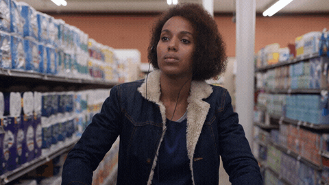 Person pushing a cart down a packed supermarket aisle, the shopping trip where scanning beats every other logging method