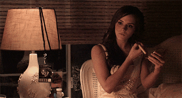 Movie gif. Emma Watson as Nicki in The Bling Ring. She absentmindedly puts powder on her face with a brush as she stares at something. Suddenly, she stops and says deadpan, "Your butt looks awesome."