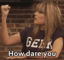 Video gif. A woman shakes her fist in the air and she pats her elbow while saying angrily, "How dare you."