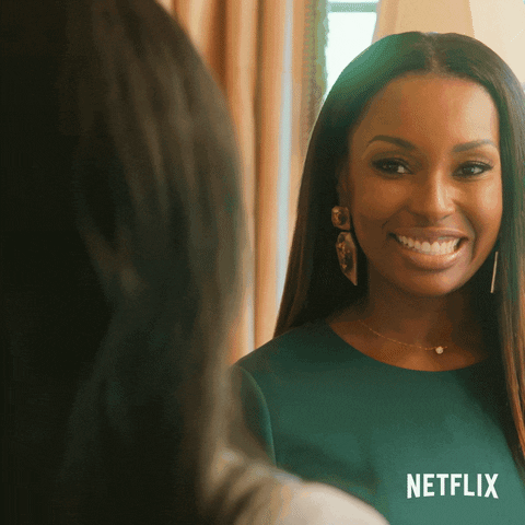 Reality TV gif. Juawana Colbert and Sharelle Rosado on Selling Tampa laugh as they high five excitedly. 