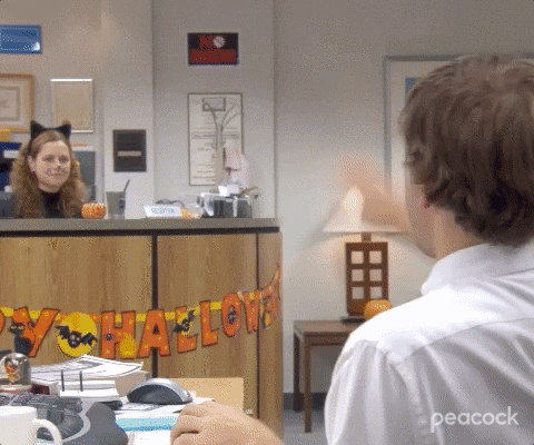 A wholesome GIF from The Office where Pam and Jim remotely high five
