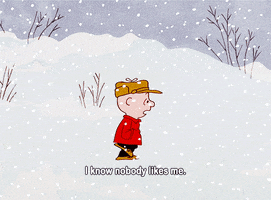 Peanuts gif. Walking through the falling snow alone, Charlie Brown looks sad and says, “I know nobody likes me.”