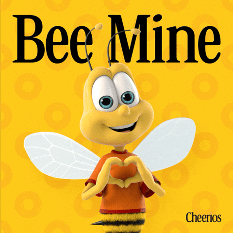 Sponsored gif. Buzz, the anthropomorphic bee mascot for Cheerios, floats gently up and down while smiling and holding his hands in the shape of a heart. The Cheerios logo is in the upper right corner, and dark yellow cheerio shapes float by on the yellow background. Text reads: Be Mine