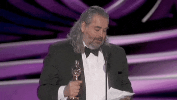 Oscars 2024 gif. Hoyte van Hoyteme wins Cinematography for Oppenheimer. He says, "You're the best thing to happen to my career. Obviously" while beckoning to the trophy in his hand to emphasize his point. 