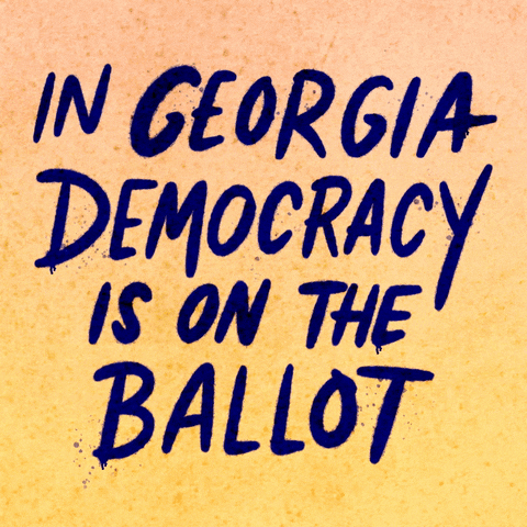 Text gif. Handwritten capitalized text against peach and yellow background reads, “In Georgia democracy is on the ballot.” A hand holding a can of blue spray paint underlines the word, “Georgia.”